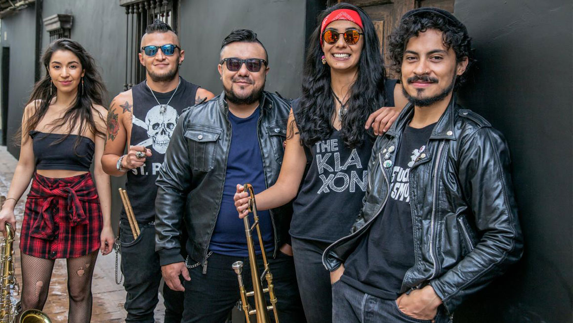 The Klaxon band performing live, blending ska, reggae, and Latin American music. Book through Originaria Events.